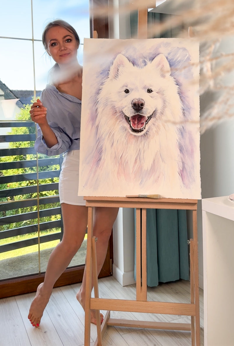 Artist holding a custom watercolor dog portrait of felix samoyed